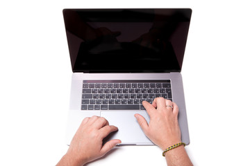 View from above. hands of a man behind a modern thin laptop. close-up. isolated on white background