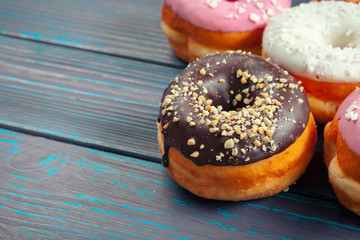 Glazed donuts on wooden background