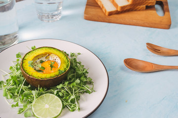 Healthy avocado toasts for breakfast or lunch with bread, sliced avocado, arugula, pumpkin and sesame seeds, salt and pepper. Vegetarian sandwiches. Plant-based diet. Whole food concept.