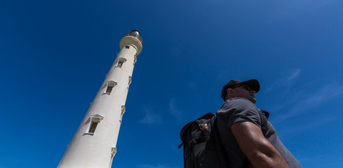 Young Photographer exploring a front  of Light House Aruba 