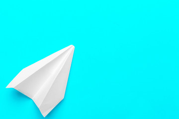 Flat lay of white paper plane and blank paper on pastel blue color background