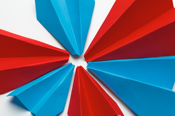 Red and blue paper planes on white background. Leadership and Business competition concepts