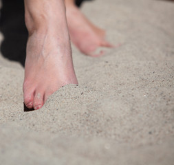 Female feet in the sand
