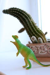 green dinosaur isolated on white backgroud with cactus