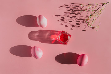 Overhead view of Easter eggs with shadows on pink background