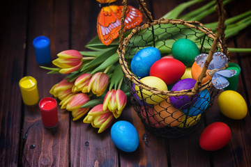 Obraz na płótnie Canvas Easter background with tulips and painted eggs 