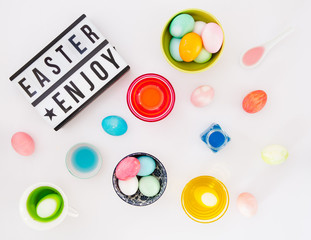 Top view of colorful easter eggs on white background