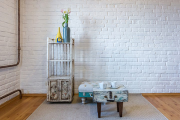 table, chairs, shelves on the background of a white brick wall in vintage loft interior