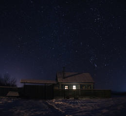 Sleeping houses in the village on a frosty and starry night in Russia