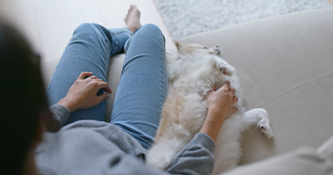 Woman Cuddle Her Dog At Home