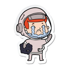 Obraz premium sticker of a cartoon crying astronaut