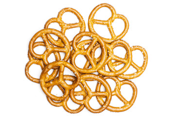 Lot of whole mini salted pretzels stack flatlay isolated on white background