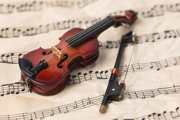 Obraz na płótnie Canvas Violin on old paper music notes with copy space