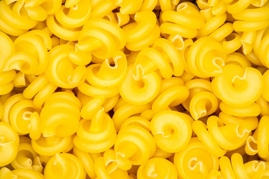 Closeup lot of whole raw pasta funghetto variety flatlay isolated
