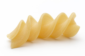 Italian twisted pasta fusilli isolated on white background. Fusilloni, rotini.
