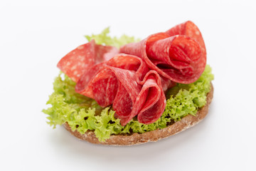 Sandwich with salami sausage on white background.
