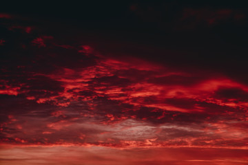 Fiery red blood vampire dawn. Amazing warm dramatic fire cloudy sky. Vivid orange sunlight....