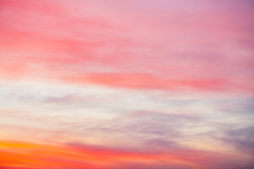 Sunset sky with pink orange light clouds. Colorful smooth blue sky gradient. Natural background of sunrise. Amazing heaven at morning. Slightly cloudy evening atmosphere. Wonderful weather on dawn.