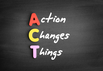 Obraz premium Color wooden alphabets building the word ACT - Action Changes Things acronym on blackboard