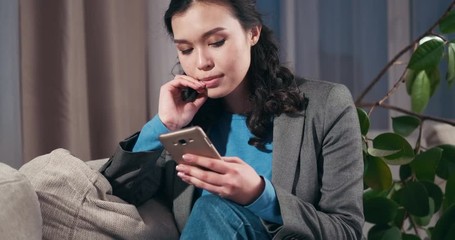 Sad businesswoman reading a bad news on mobile phone at home