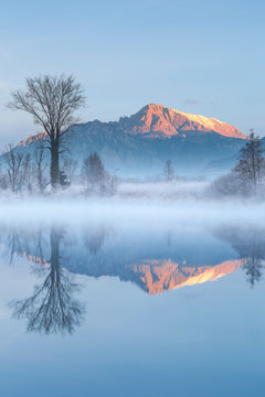 First lights on Grignetta mount (Grigna Meridionale) reflected on Adda river, Airuno, Brianza, Lecco province, Lombardy, Italy, Europe