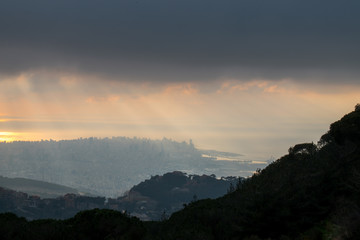 This is a capture of the sunset in Beirut capital of Lebanon with a warm orange color covered with a heavy mist and some rainy cloud