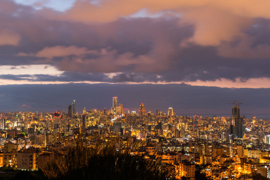 This is a capture of the sunset in Beirut capital of Lebanon with a warm orange color, and you can see Beirut downtown in the foreground with some beautiful cloud in the background