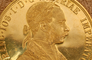 Portrait of Franz Joseph I on obverse of old gold Austrian four ducats coin.