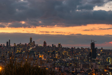 This is a capture of the sunset in Beirut capital of Lebanon with a warm orange color, and you can see Beirut downtown in the foreground with some beautiful cloud in the background