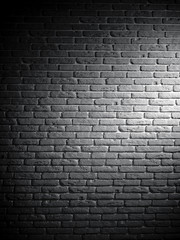 Background of black and white brick textured vintage wall with light pattern