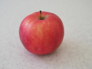 Close up red Apple isolated on marble table.