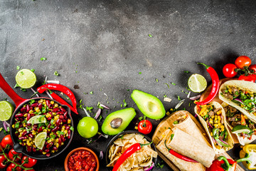 Cinco de Mayo food.Mexican food concept background with taco, quesadilla, burrito, chili, salsa sauce, hot pepper, lime. Black concrete background top view copy space - obrazy, fototapety, plakaty