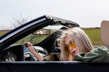 young blond woman in the car