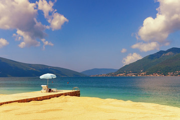 Obraz premium Vacation on the sea. Montenegro, Adriatic Sea, view of Bay of Kotor near Tivat city on sunny spring day
