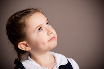 Pensive Little Student Girl Deep in Thought