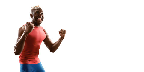 Isolated happy Beautiful black male athlete. Man sprinter in sport clothes emotionally rejoices victory on white background
