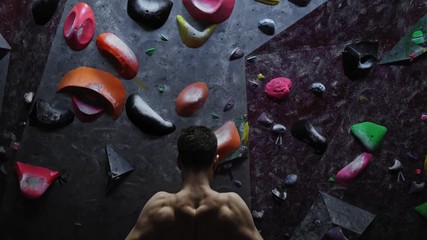 Athletic man warming up in a bouldering gym