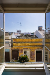 Hotel window Faro Portugal street view with plant in window