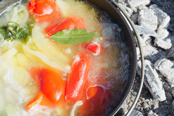 Shurpa soup in cast-iron cauldron outdoor. Food for hike.