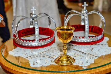 Two crowns and a glass of wine for orthodox wedding