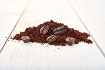 Ground coffee isolated on a wooden table