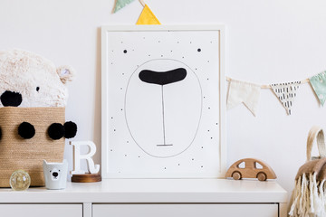 Stylish scandinavian newborn baby room with toys, teddy bear, cotton flags and natural basket....