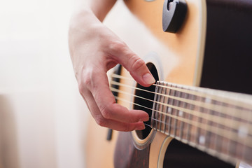 Fototapeta premium woman's hands playing acoustic guitar, close up