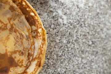 Cheese pancakes with sour cream on kithcen table