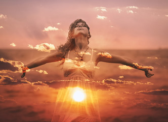 Double exposure of young woman and sunset sky. - obrazy, fototapety, plakaty