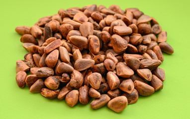 Pile of walnut on green background.