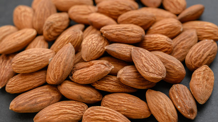 Pile of almon on dark background.