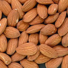 Pile of almon on dark background.