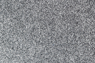 White spray paint drops on black paper. Grunge ink splatter texture for graphic design.