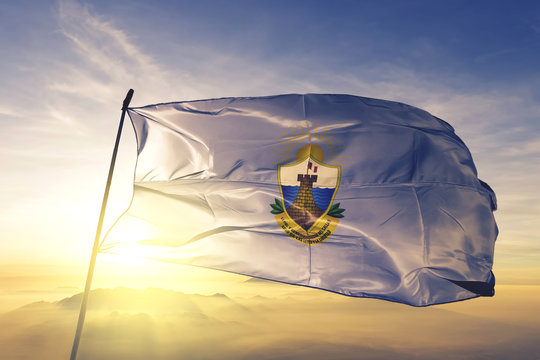 Callao region of Peru flag waving on the top sunrise mist fog